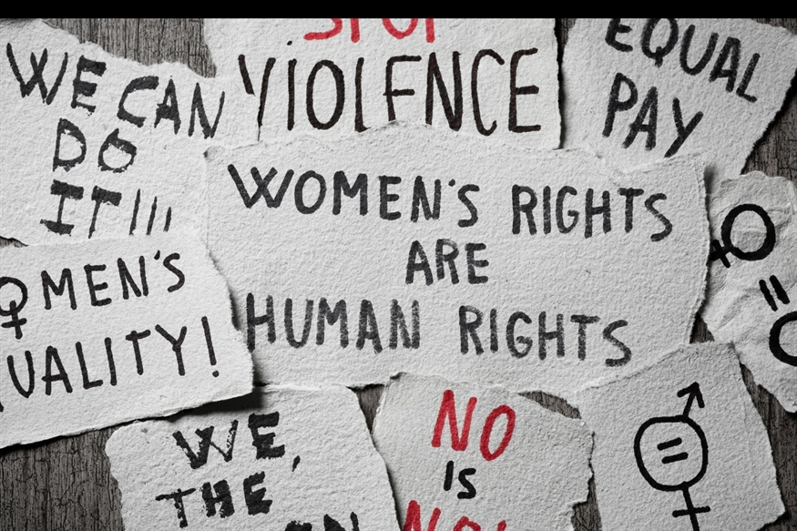[ai] A collection of handwritten signs on textured paper, with phrases advocating for women's rights, such as "Women's Rights Are Human Rights," "Equal Pay," and "No Is No," among others.